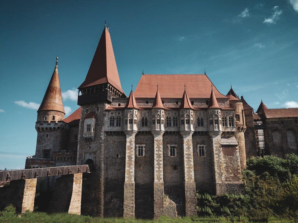 A picture of Corvin Castle in Romania on a beautiful sunny day.