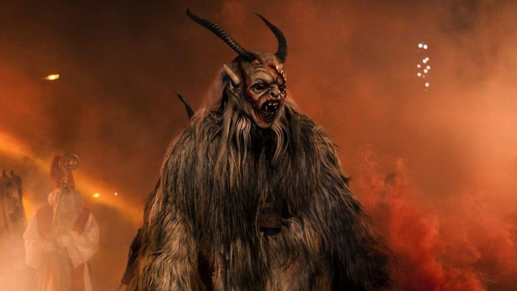 A picture of someone dressed as Krampus surrounded by colored smoke.