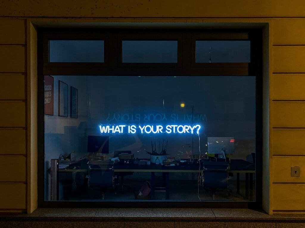 A picture of a window display featuring a sign that says, "Whats Your Story?"